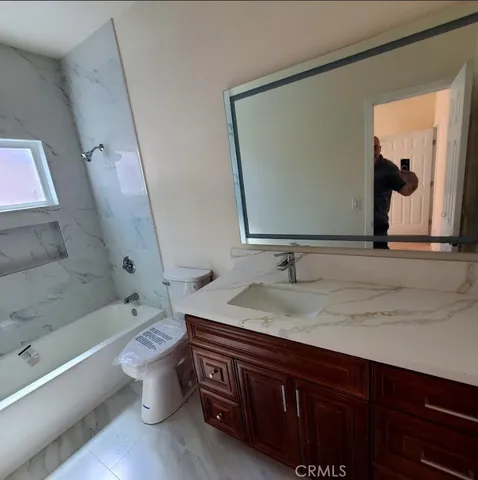 a bathroom with a bathtub and a sink