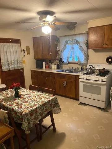 a kitchen with a stove a sink and a refrigerator