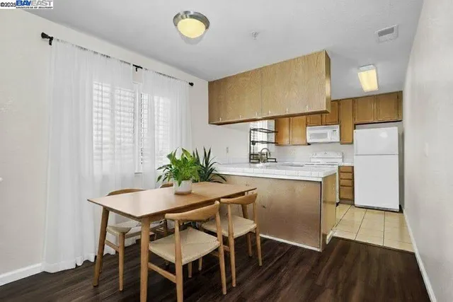 a dining room with a wooden table and chairs