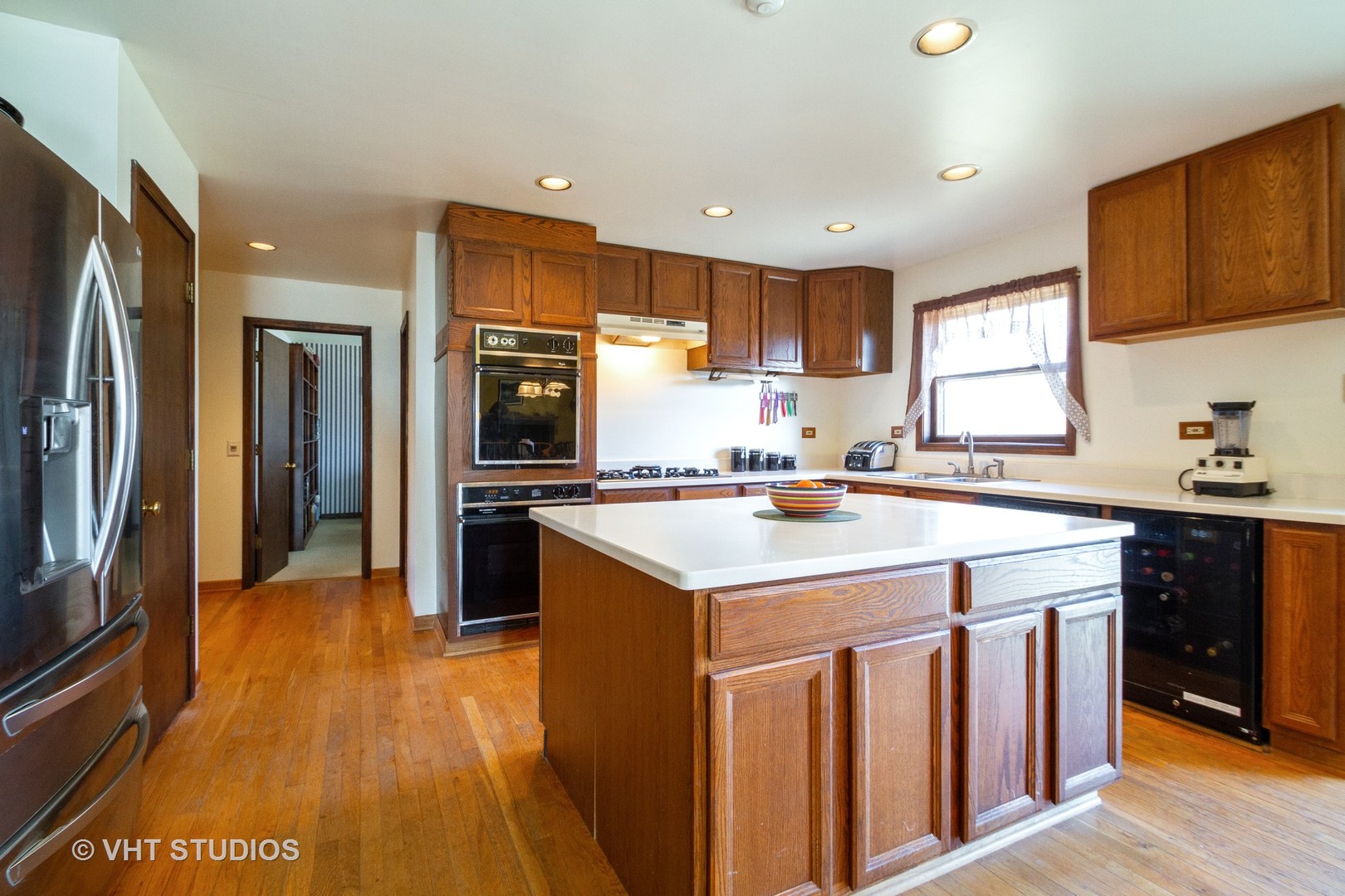 6514 Johnson Road Hebron, IL 60034 - Photo 6 of 17 a kitchen with a sink a refrigerator and wooden floor