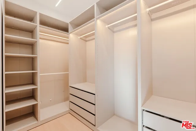 a bathroom with a granite countertop sink a toilet a mirror and shower