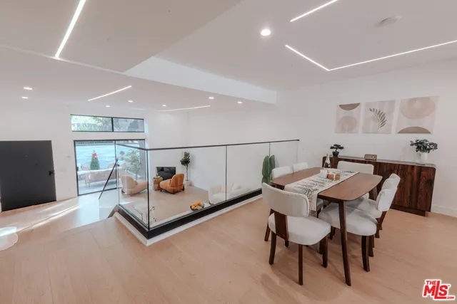 a hallway with stairs and a couch