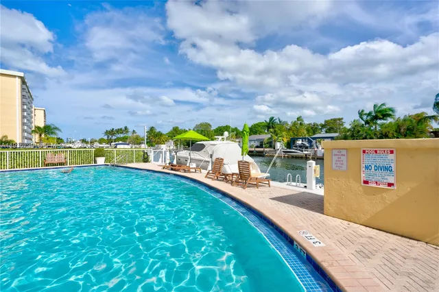 a view of a swimming pool with an outdoor seating