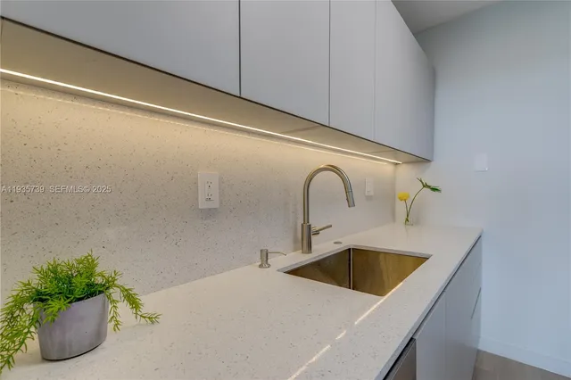 a kitchen with a sink and washing machine