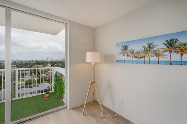 a view of a living room and a floor to ceiling window