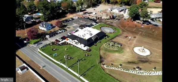 a view of outdoor dining space with chairs and potted plants