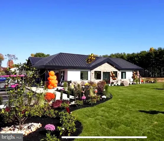 a view of a house with backyard porch and furniture