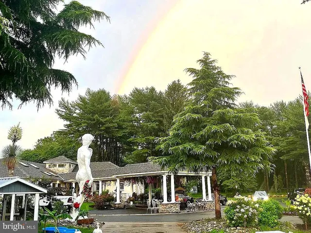 a front view of multiple houses with yard