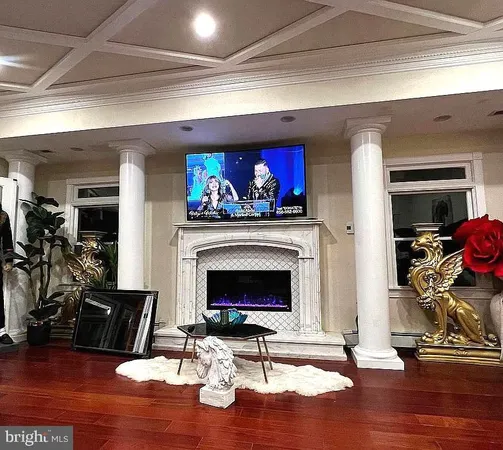 a living room with fireplace furniture and a wooden floor