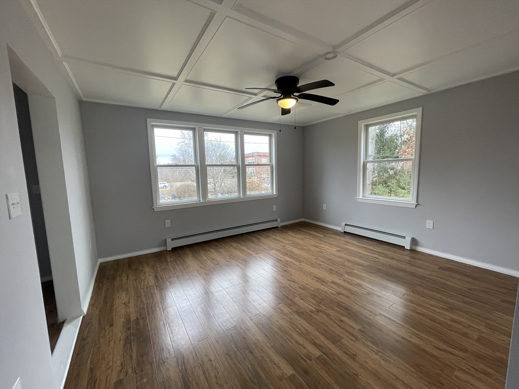 59 High Street Warren, MA 01083 - Photo 35 of 42 an empty room with wooden floor and windows