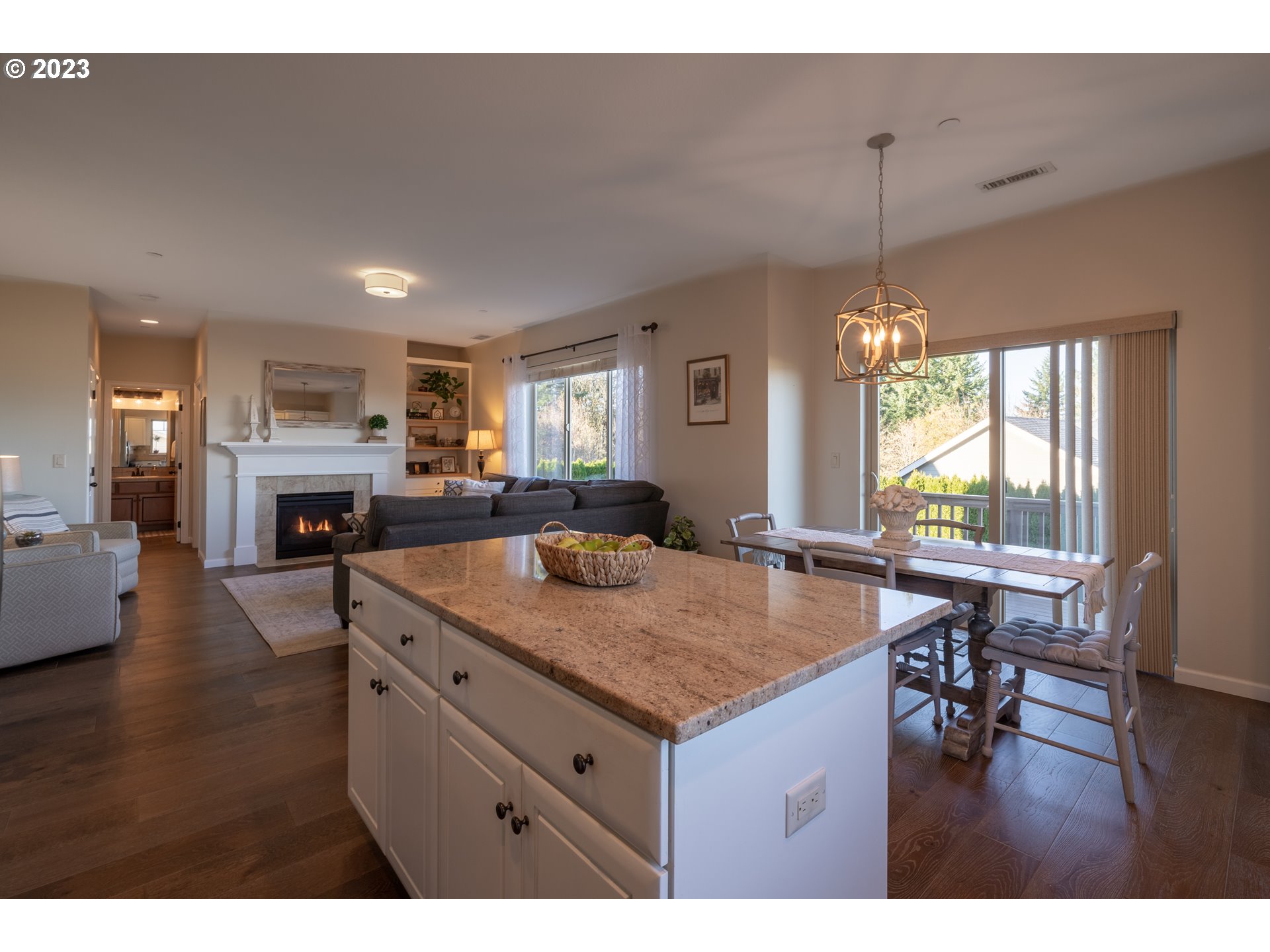 2909 Northwest Hill Street Camas, WA 98607 - Photo 12 of 42 a kitchen with a stove a refrigerator a sink dishwasher with a dining table and chairs with wooden floor