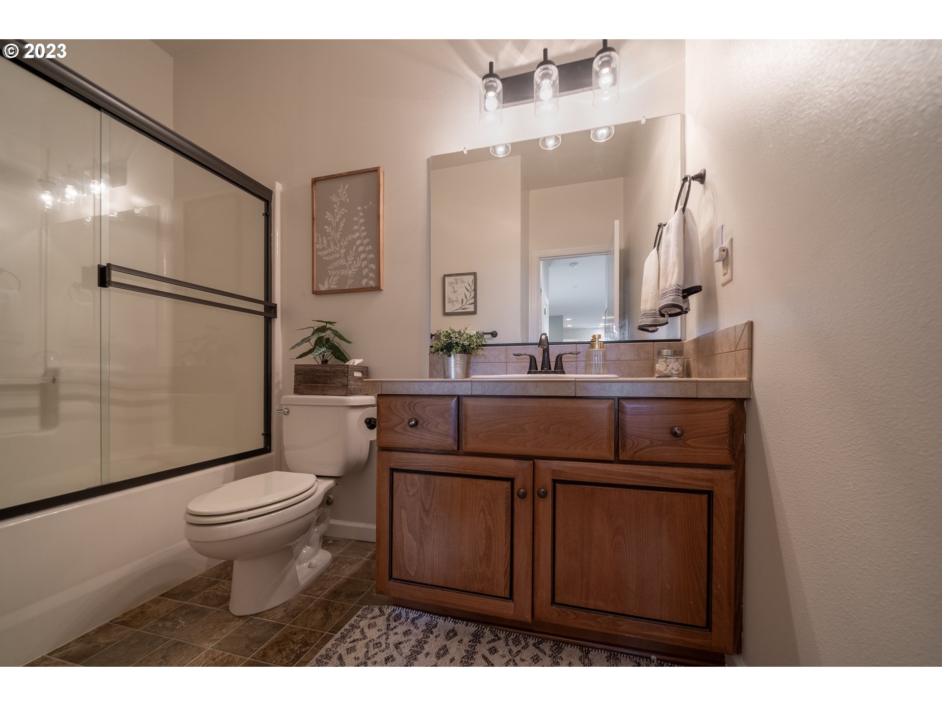 2909 Northwest Hill Street Camas, WA 98607 - Photo 18 of 42 a bathroom with a sink a toilet a mirror and shower