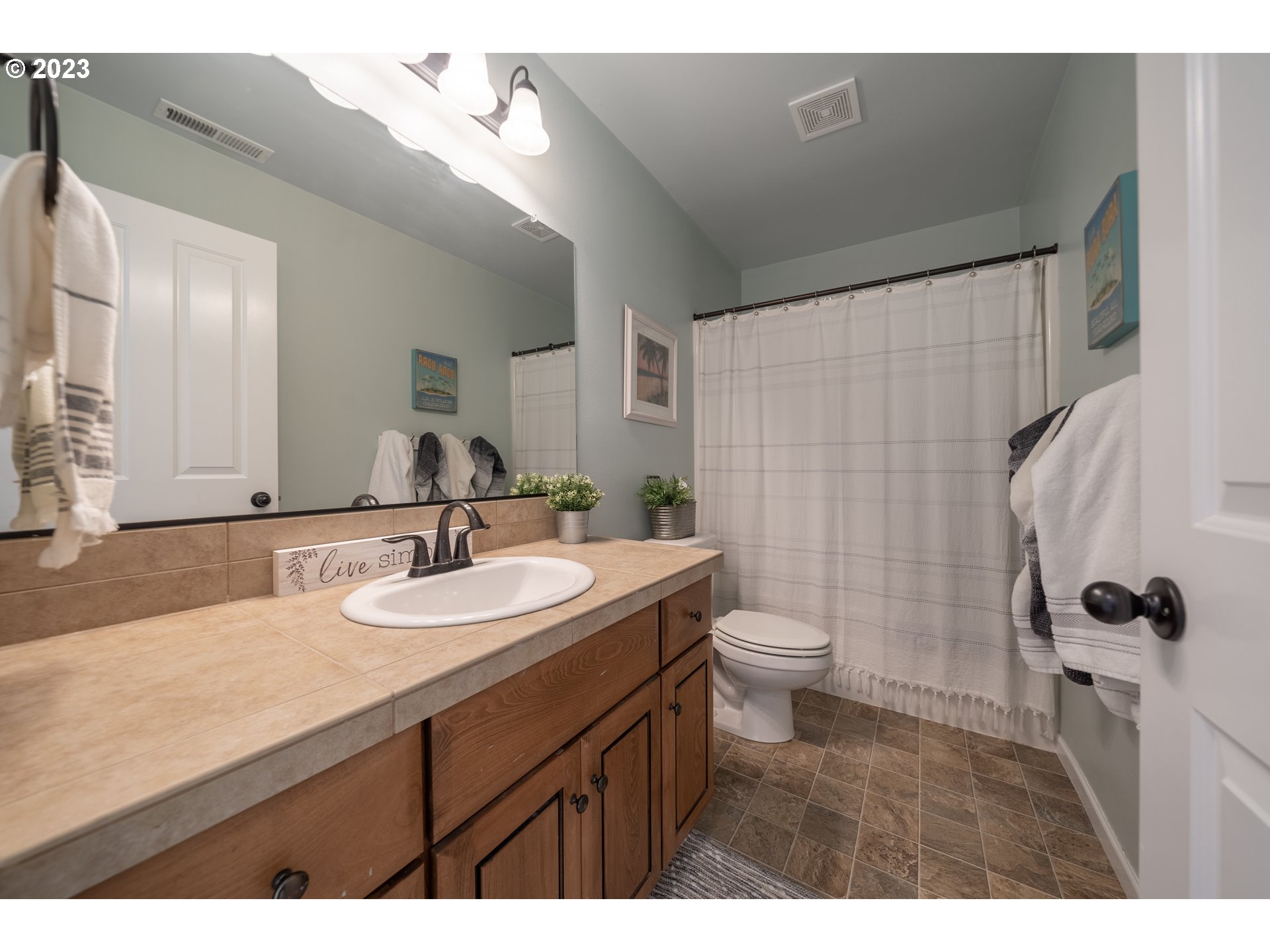 2909 Northwest Hill Street Camas, WA 98607 - Photo 32 of 42 a bathroom with a sink a toilet and a mirror