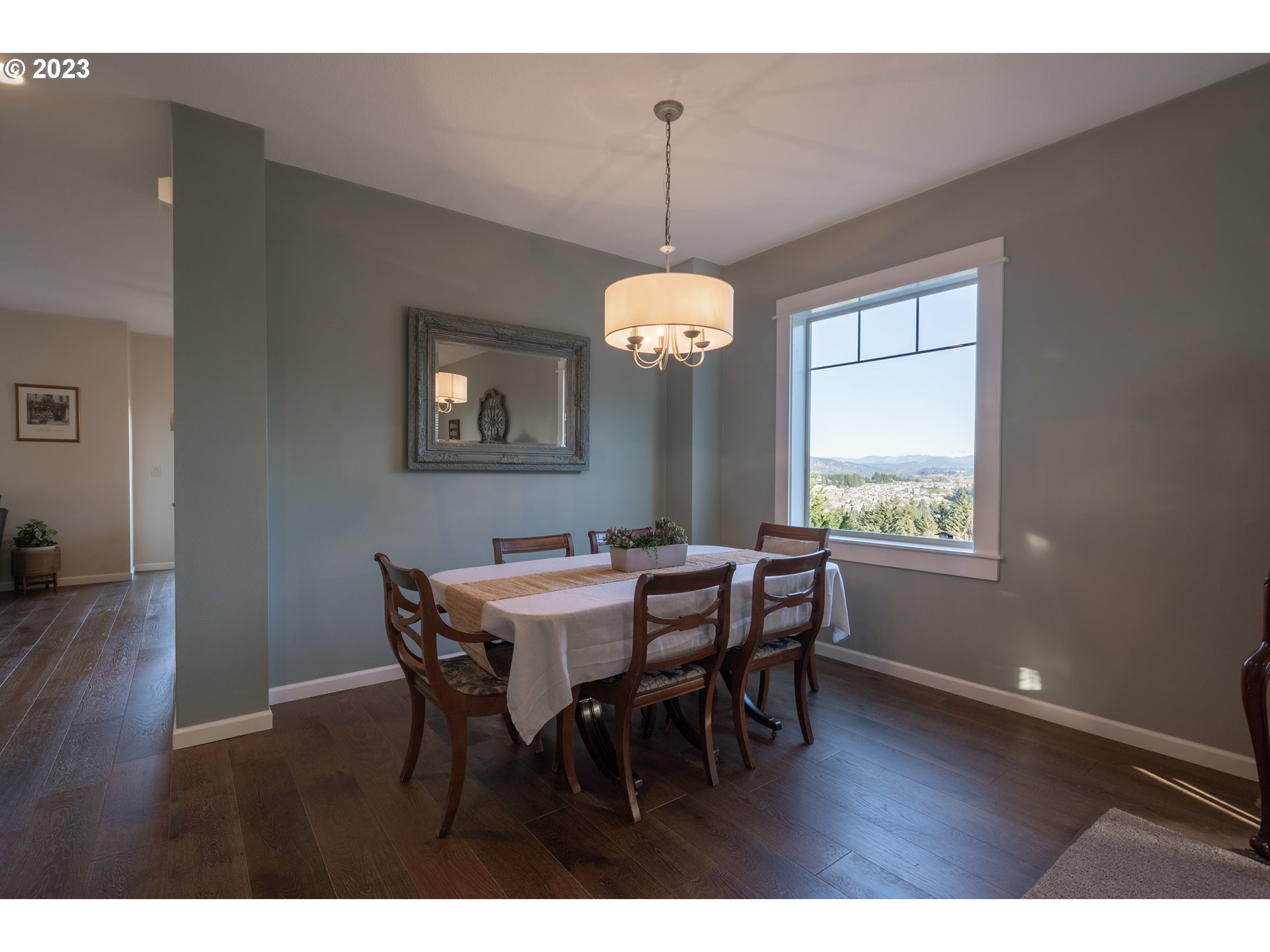 2909 Northwest Hill Street Camas, WA 98607 - Photo 6 of 42 a dining room with wooden floor a chandelier a wooden table and chairs