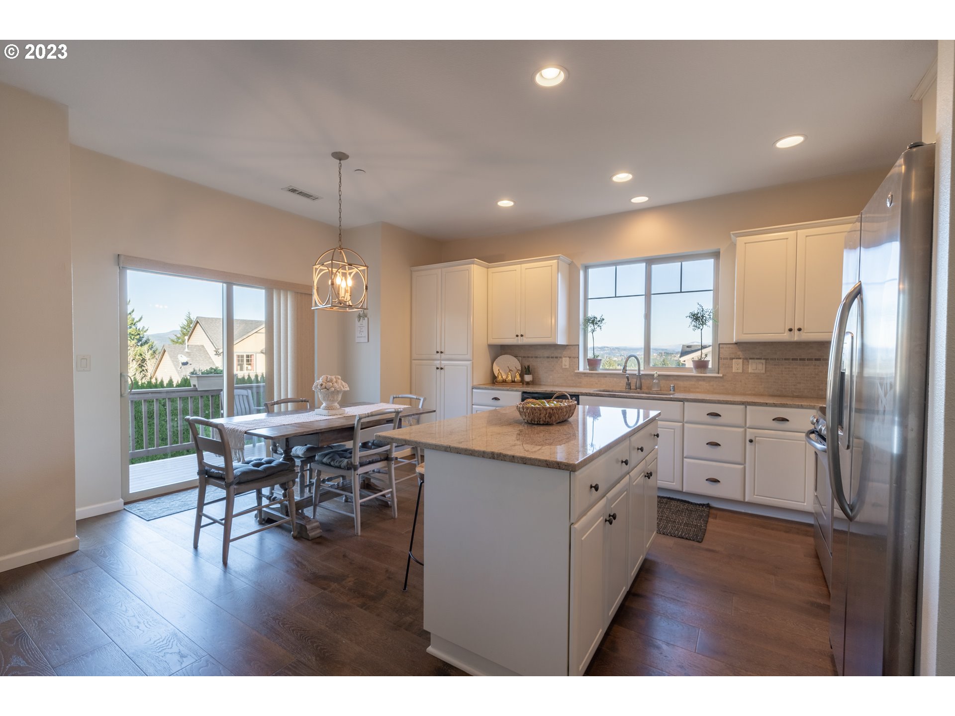 2909 Northwest Hill Street Camas, WA 98607 - Photo 8 of 42 a kitchen with stainless steel appliances granite countertop a sink a stove a refrigerator dining table and chairs