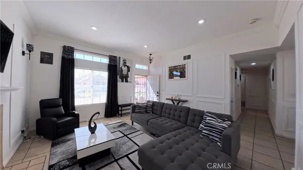 a living room with furniture and large windows