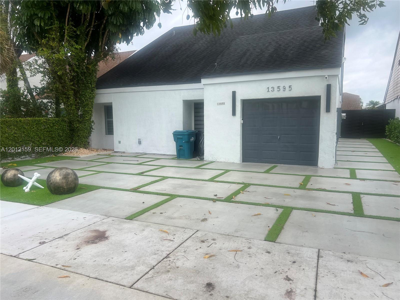 13595 Southwest 99th Street Miami, FL 33186 - Photo 1 of 44 a view of a house with a yard