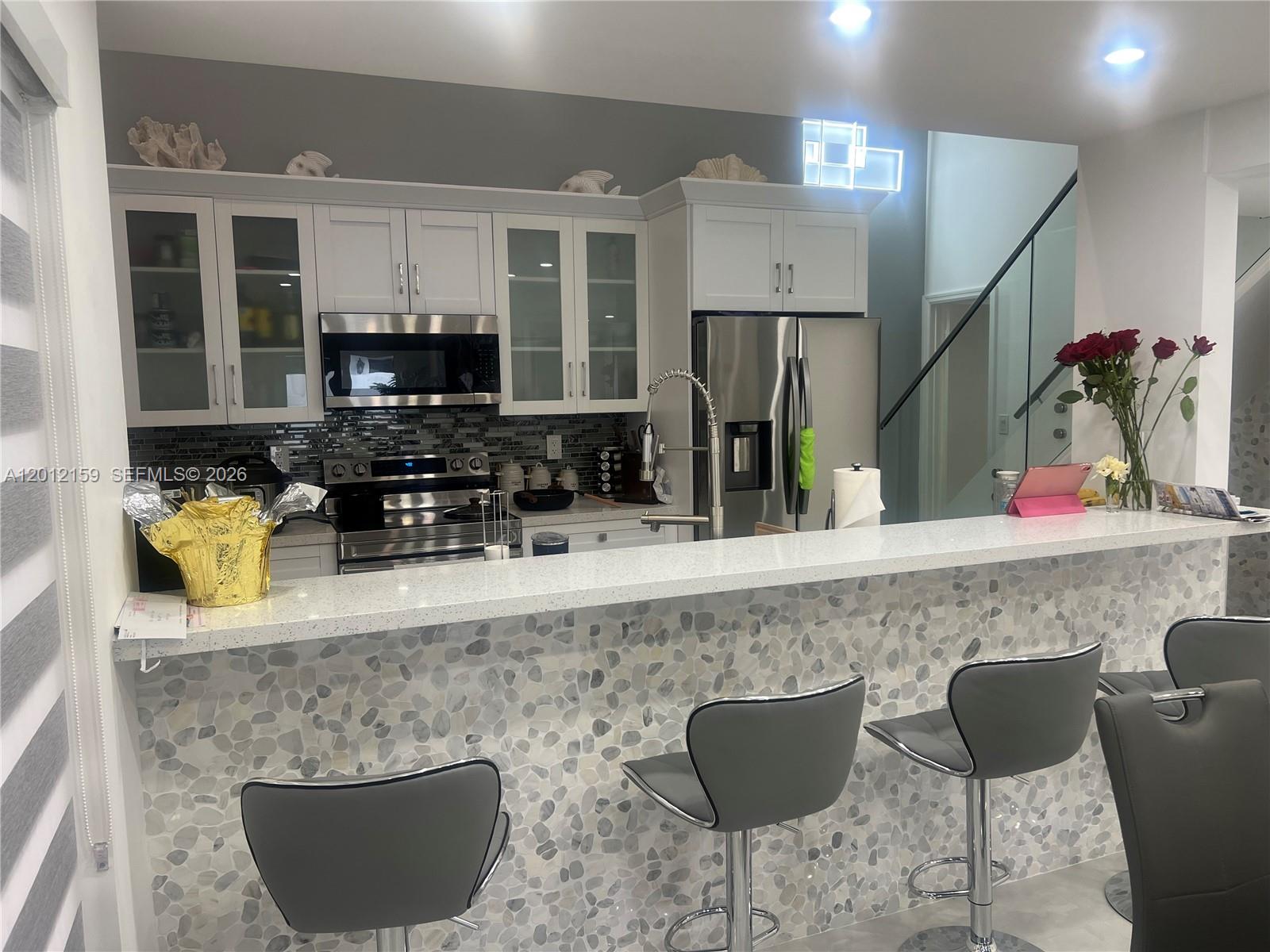 13595 Southwest 99th Street Miami, FL 33186 - Photo 17 of 44 a kitchen with stainless steel appliances granite countertop a sink and a granite counter tops