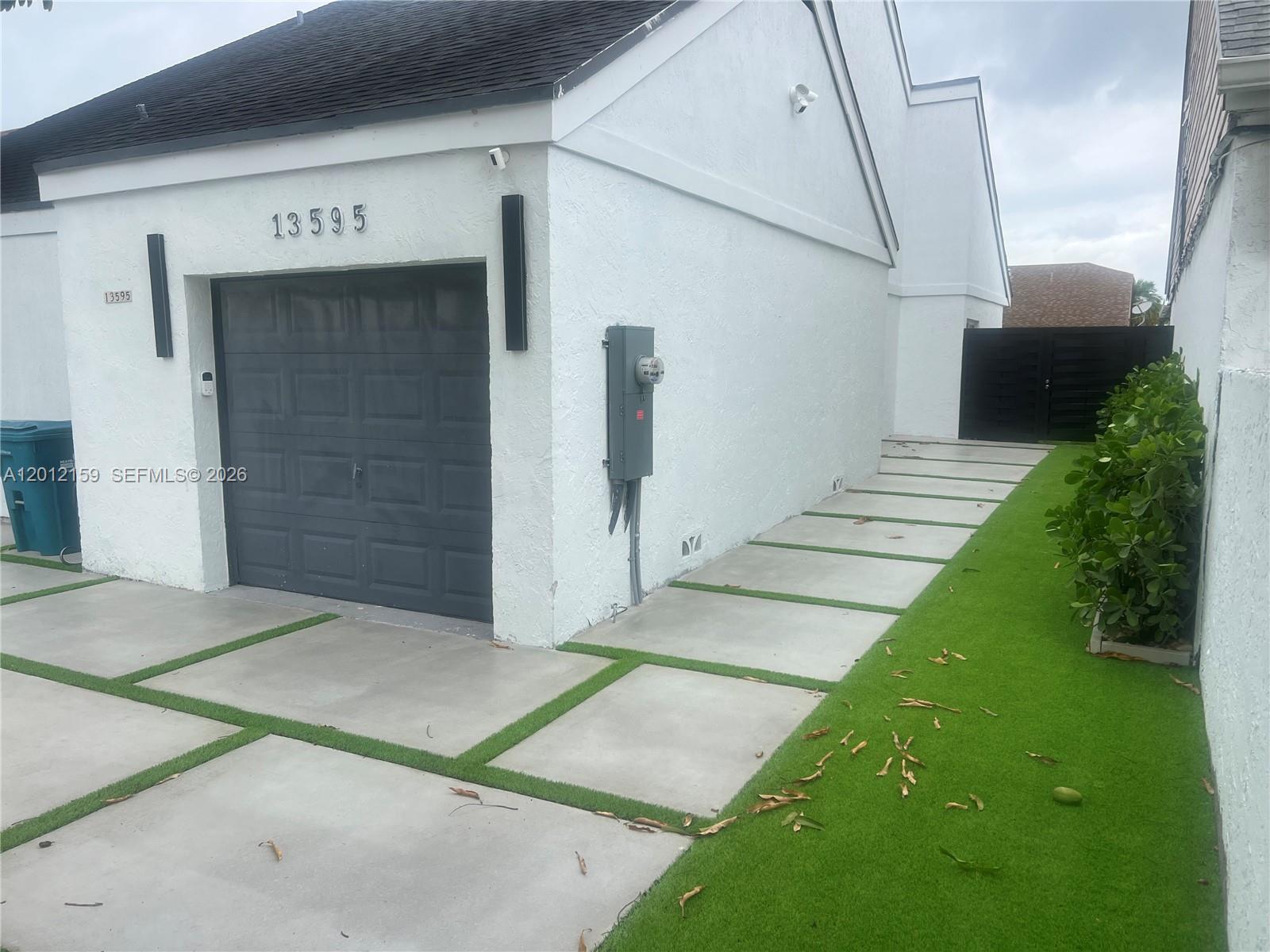 13595 Southwest 99th Street Miami, FL 33186 - Photo 3 of 44 a view of a garage door