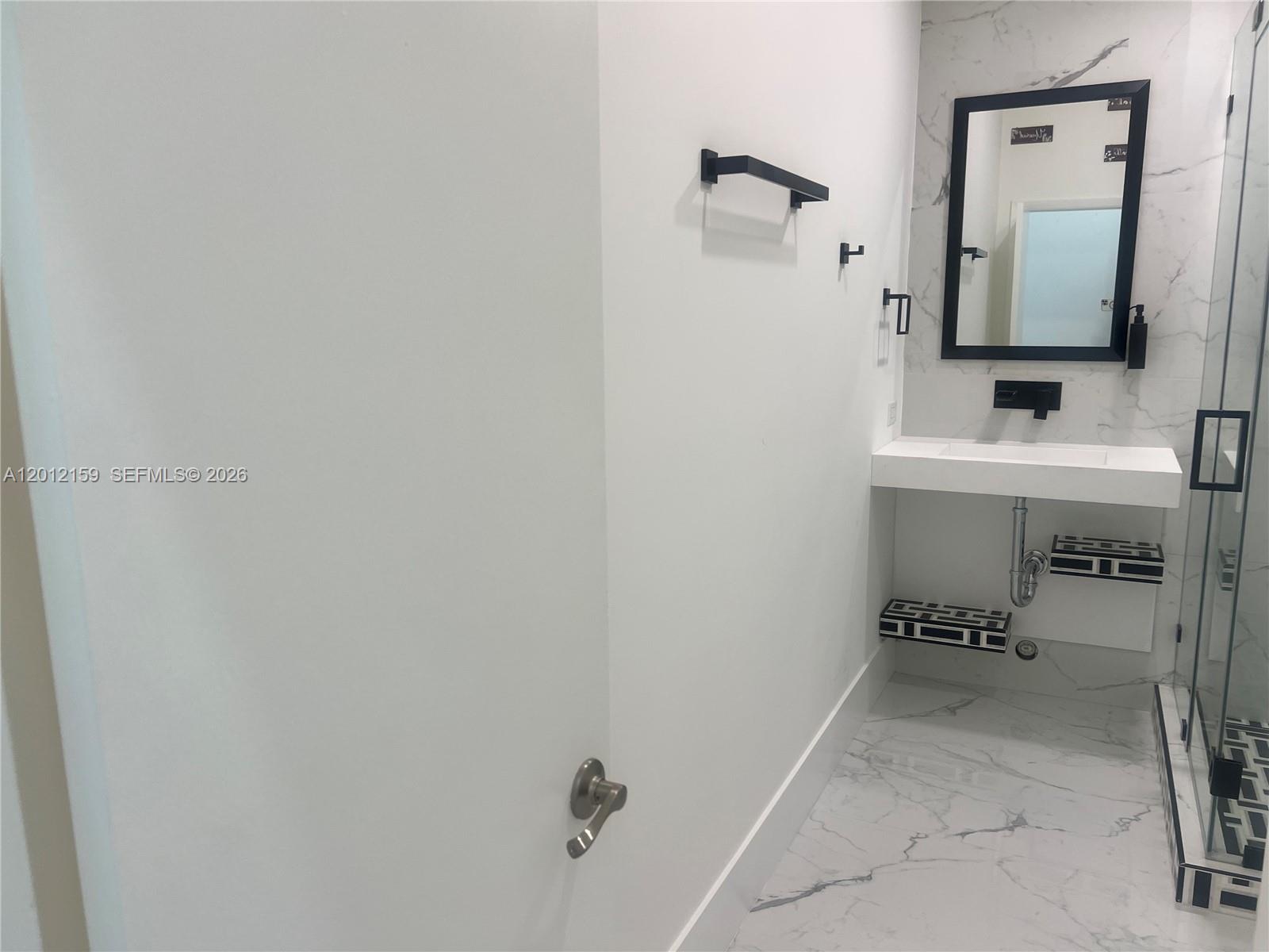 13595 Southwest 99th Street Miami, FL 33186 - Photo 32 of 44 a bathroom with a sink and a mirror