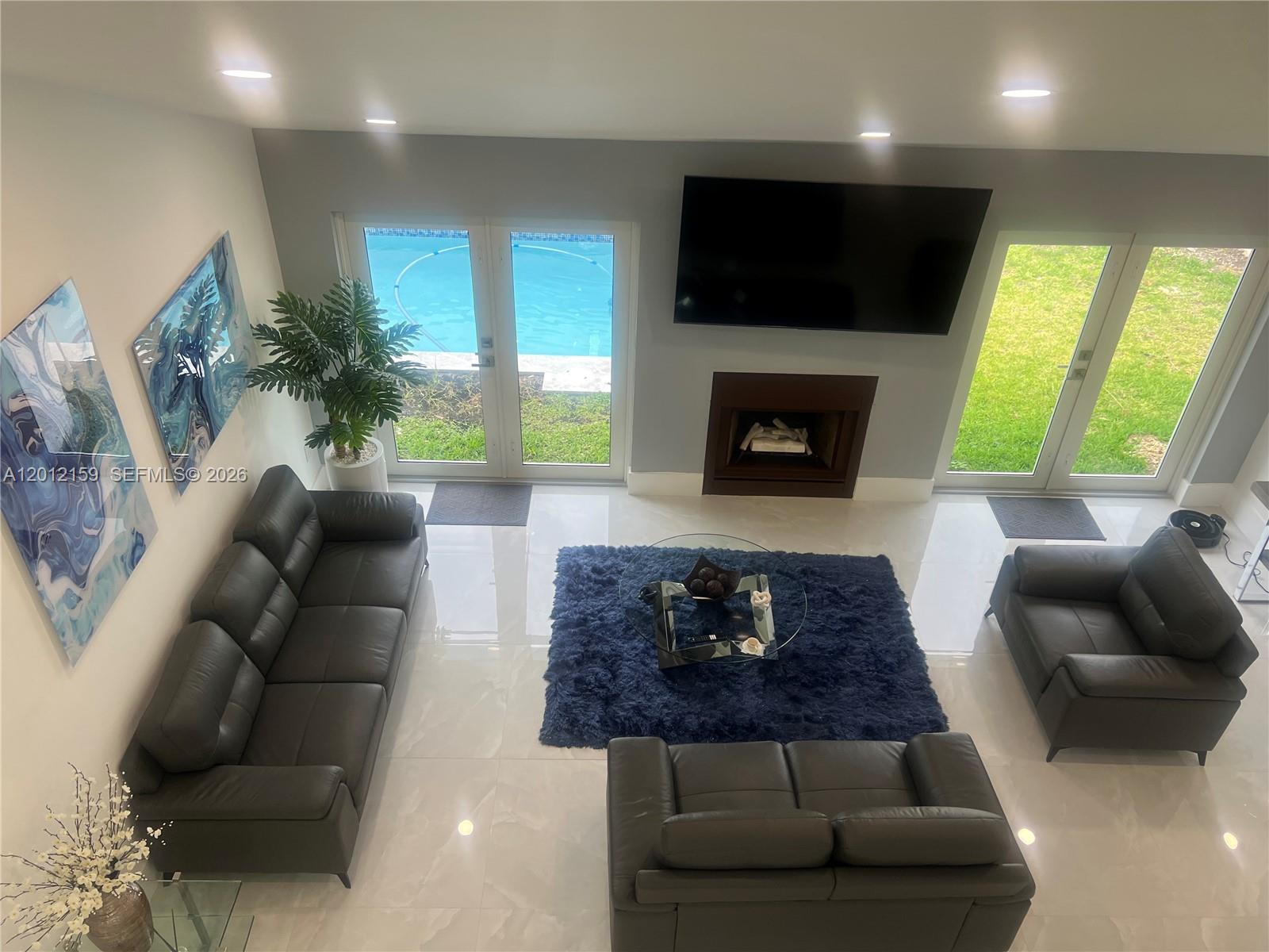 13595 Southwest 99th Street Miami, FL 33186 - Photo 39 of 44 a living room with furniture and a fireplace