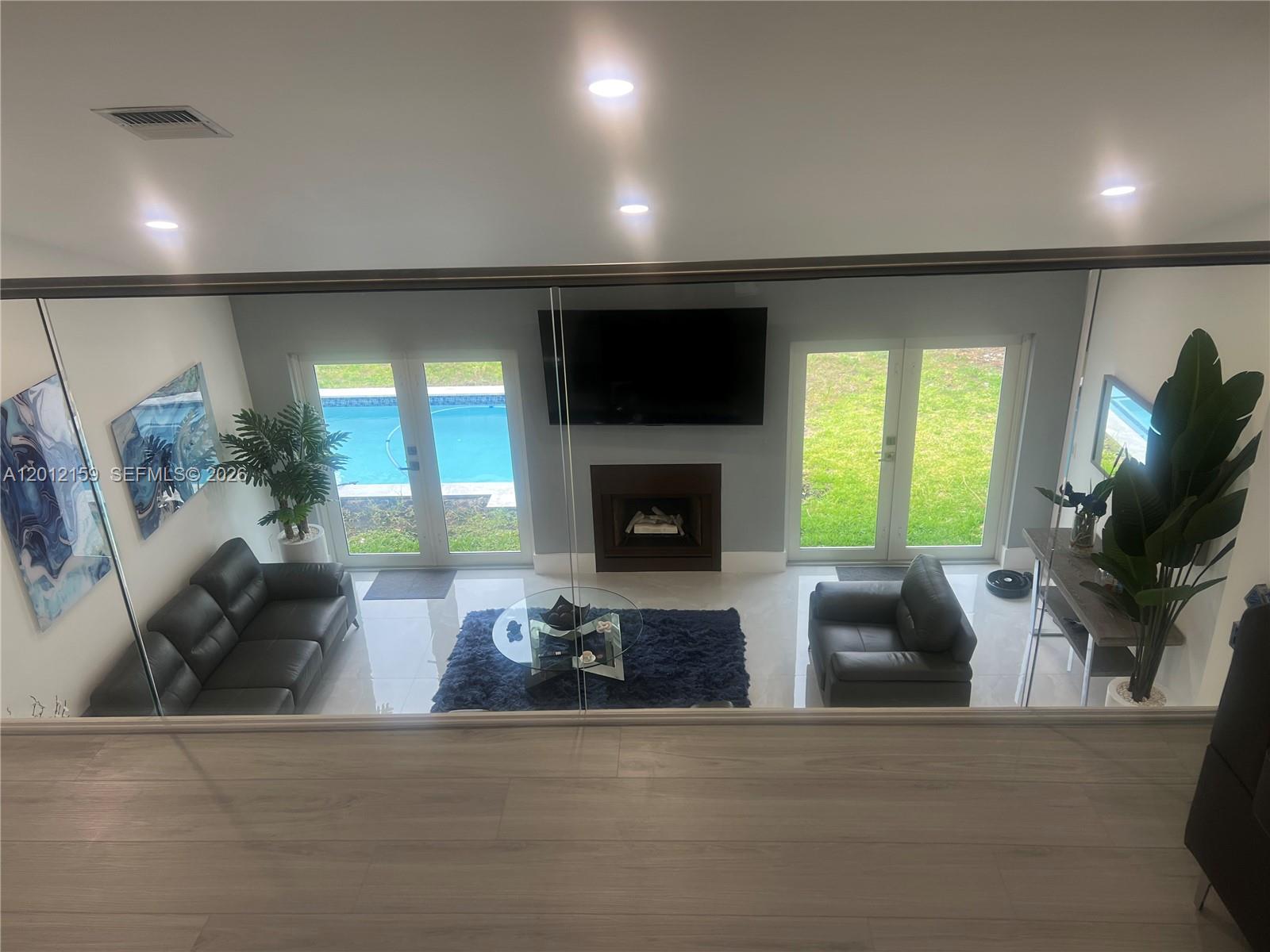 13595 Southwest 99th Street Miami, FL 33186 - Photo 43 of 44 a living room with furniture and a flat screen tv
