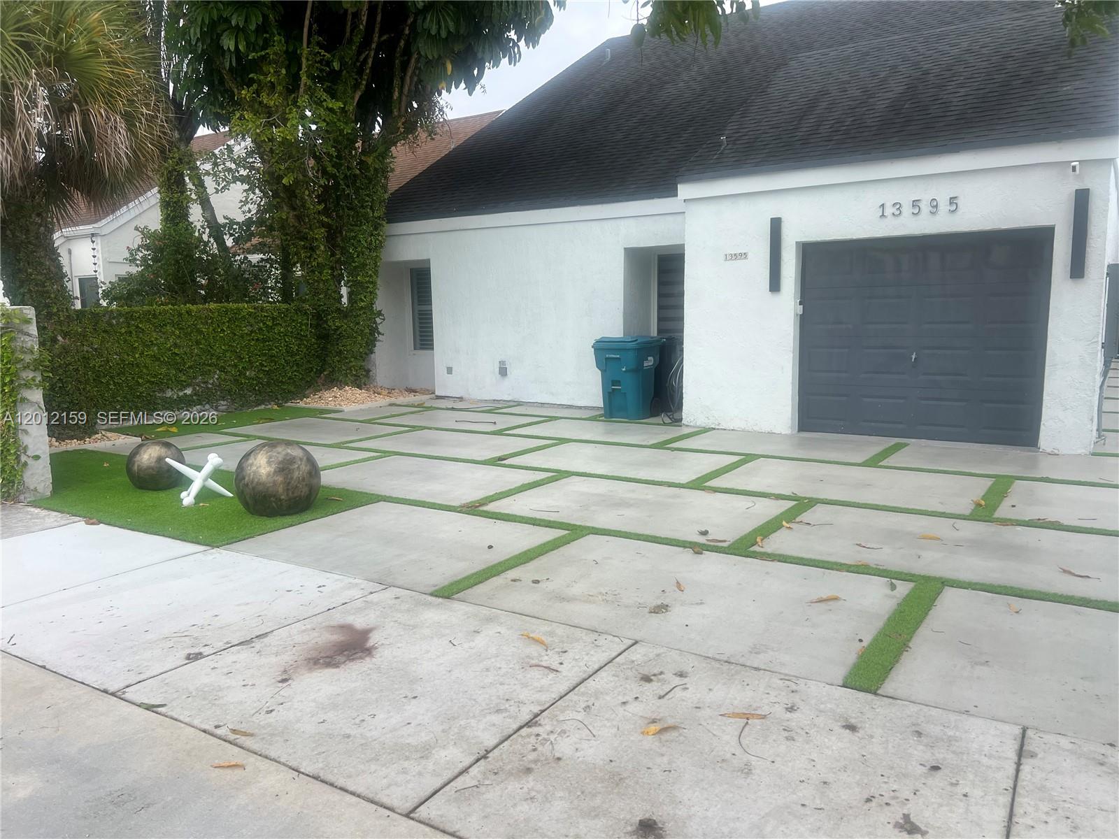 13595 Southwest 99th Street Miami, FL 33186 - Photo 8 of 44 a view of a house with a yard and garage