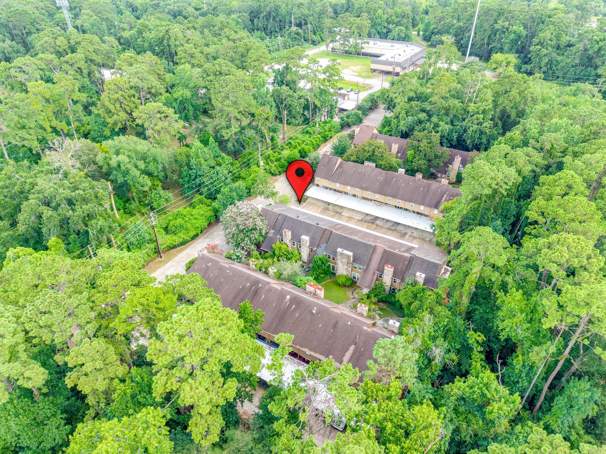 1011 Hamblen Road, Unit 306 Houston, TX 77339 - Photo 33 of 38 Pulling back even further, this view captures the property's position within the surrounding trees and nearby streets, showing just how tucked away and green this pocket of Kingwood really is.