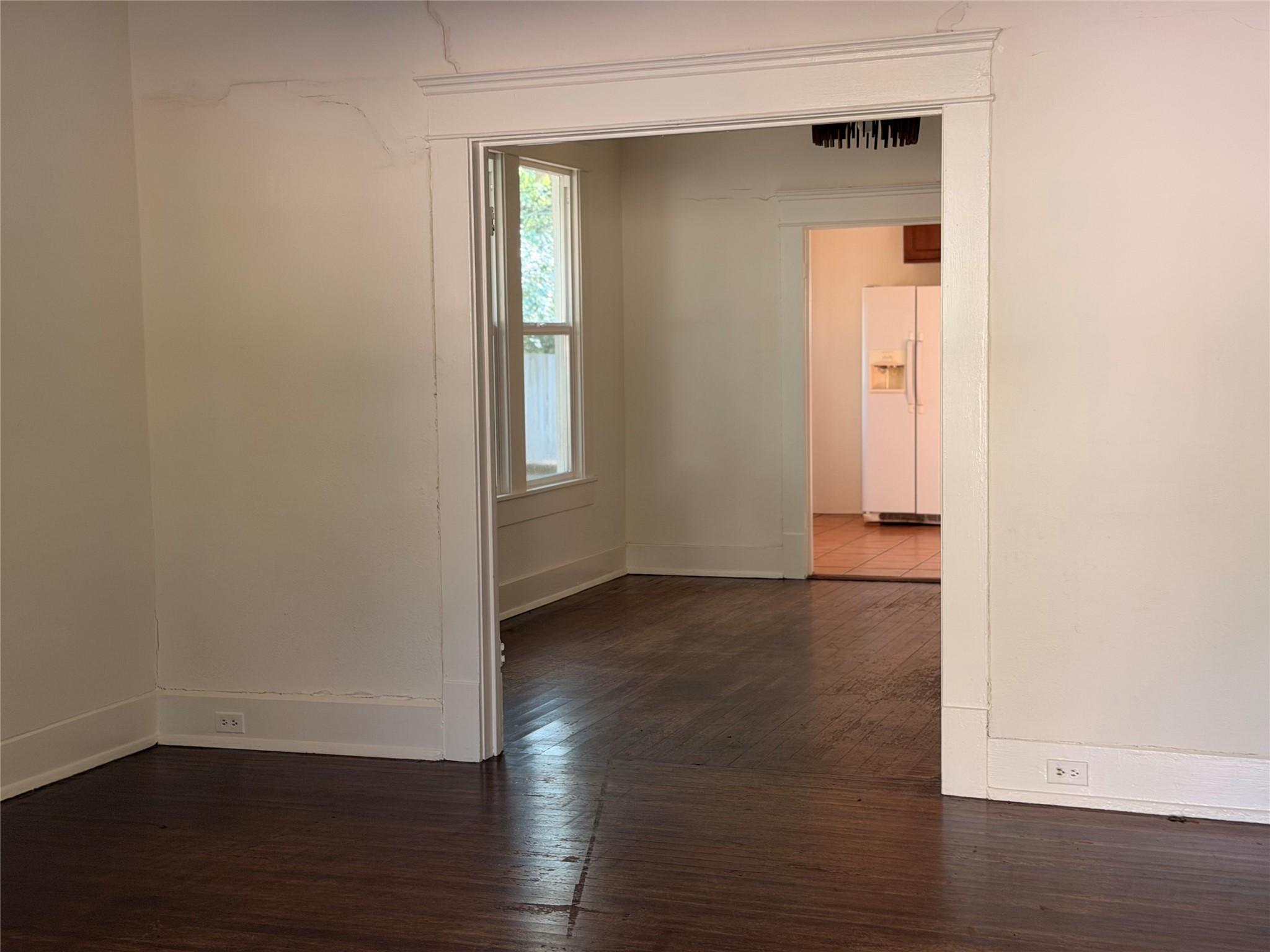 1136 Eleanor Street Austin, TX 78721 - Photo 21 of 30 Hardwood flooring extends throughout the living spaces, leading to a bright kitchen.