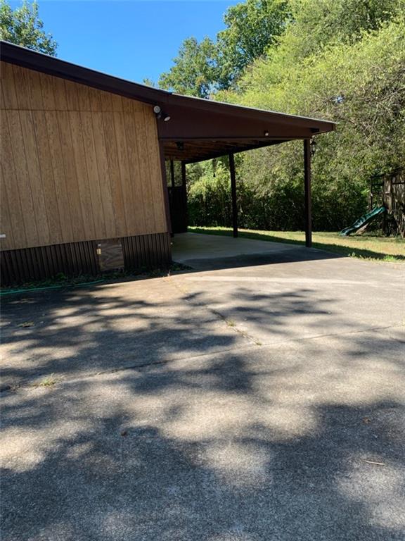 1314 Old Mill Road Ball Ground, GA 30107 - Photo 1 of 1 Side entry to covered parking