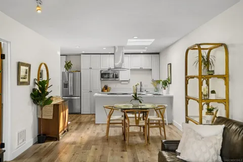 a living room with furniture a dining table and wooden floor