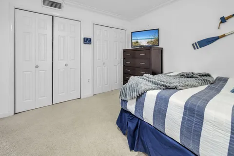 a bedroom with a bed and a mirror