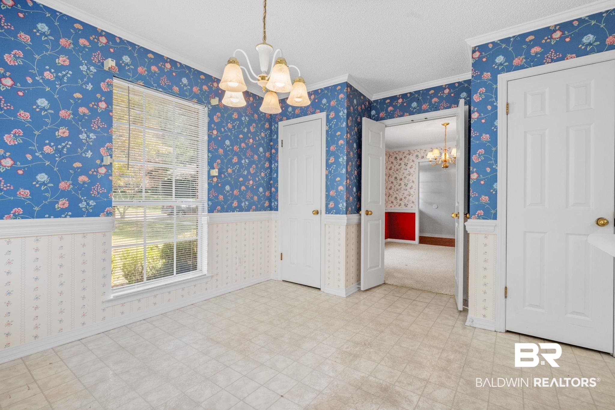 1340 Wellsley Court Mobile, AL 36695 - Photo 19 of 37 Unfurnished dining area with a chandelier, crown molding, wallpapered walls, and a wainscoted wall