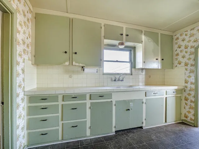 a kitchen with stainless steel appliances a refrigerator sink and cabinets