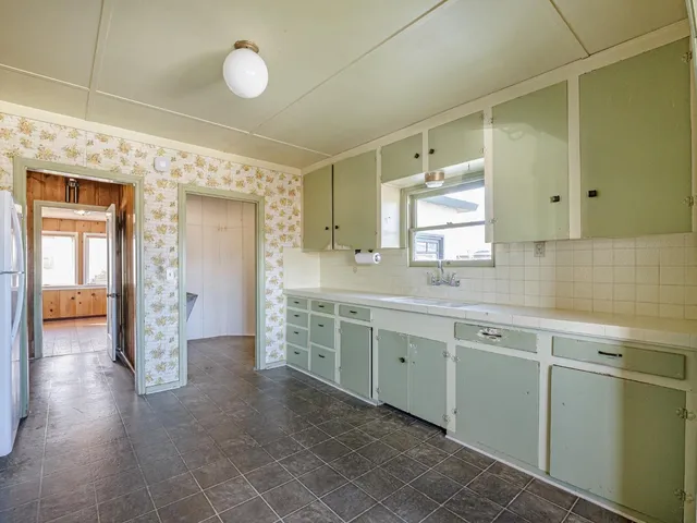 a kitchen with granite countertop cabinets and stainless steel appliances
