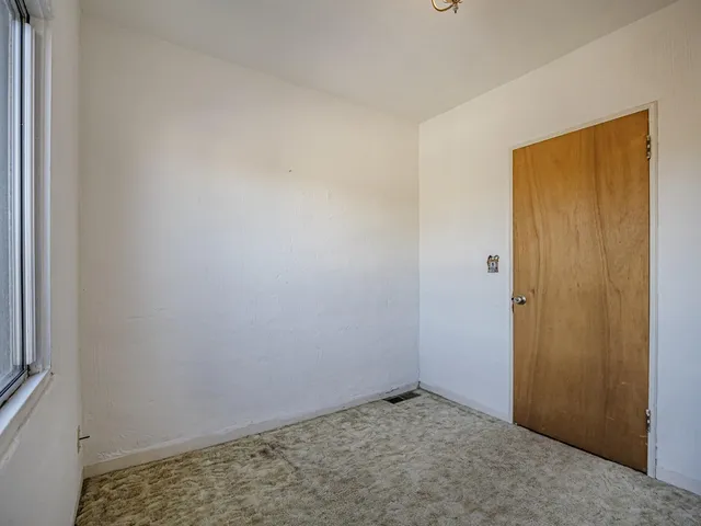 a view of an empty room and window
