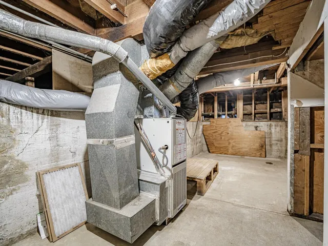 a view of an empty room with wooden floor and stairs