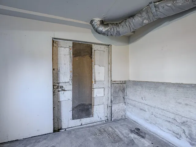 a view of a backyard with plants and wooden fence