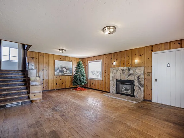 an empty room with furniture and a fireplace