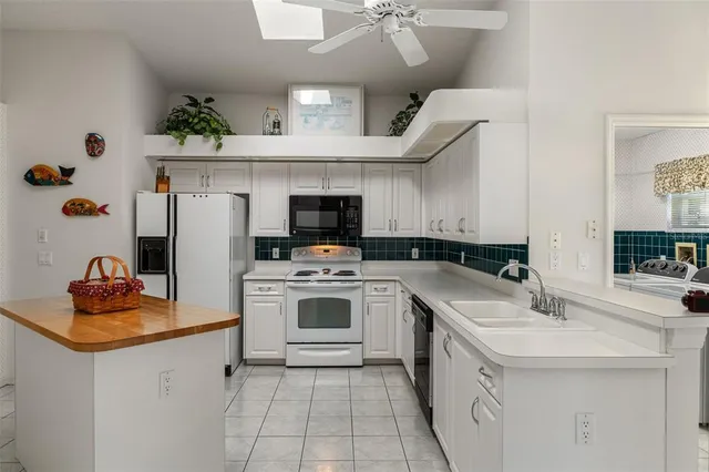 a kitchen with a sink a stove and cabinets