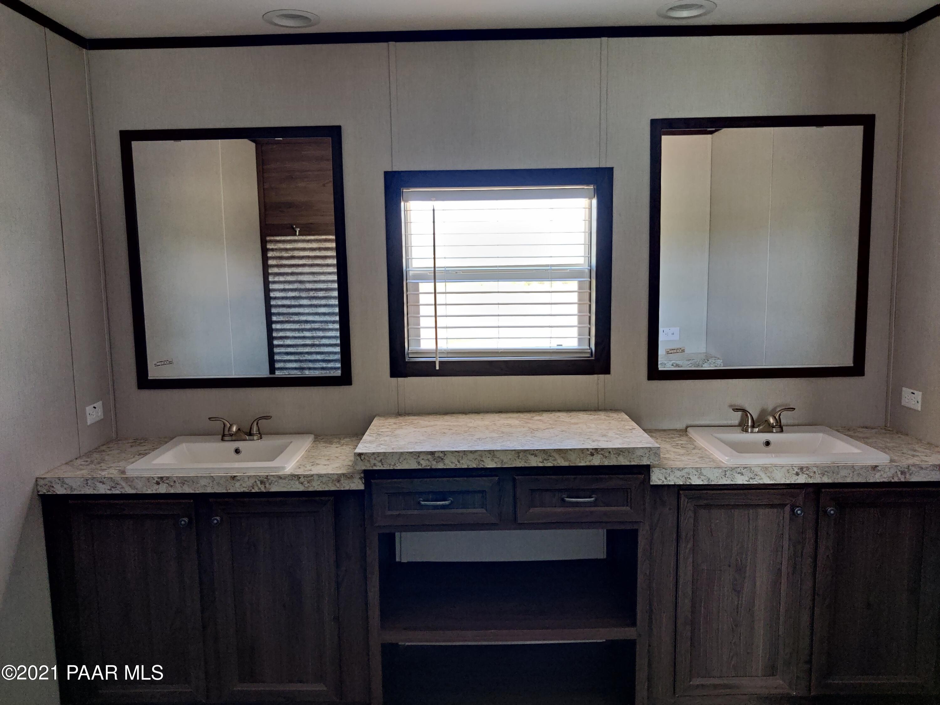 1425 West Antelope Run Road Paulden, AZ 86334 - Photo 7 of 9 a bathroom with a granite countertop sink and a mirror