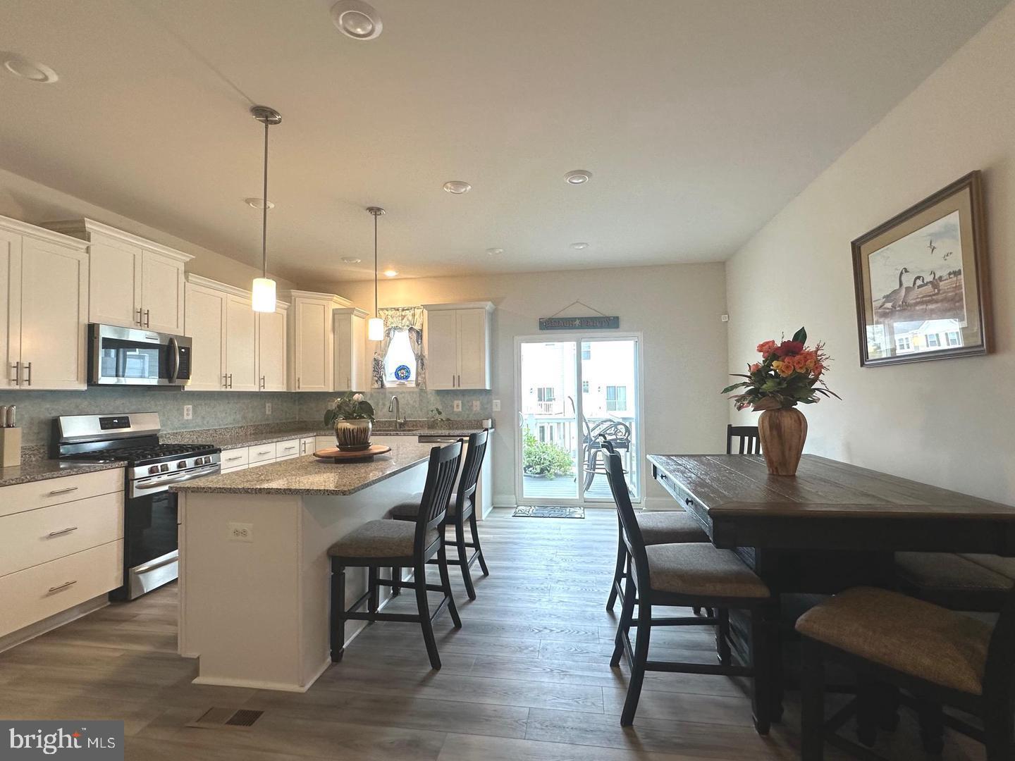 35393 Wright Way Millsboro, DE 19966 - Photo 5 of 28 a view of a dining room with furniture window and wooden floor