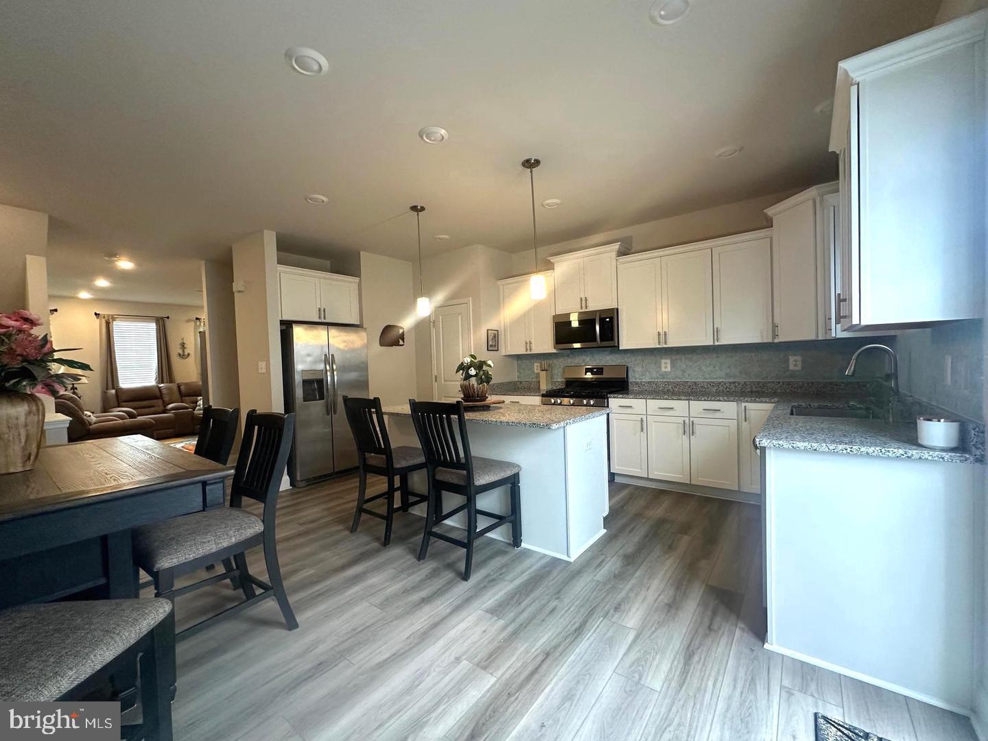 35393 Wright Way Millsboro, DE 19966 - Photo 8 of 28 a large white kitchen with lots of counter space a sink and appliances