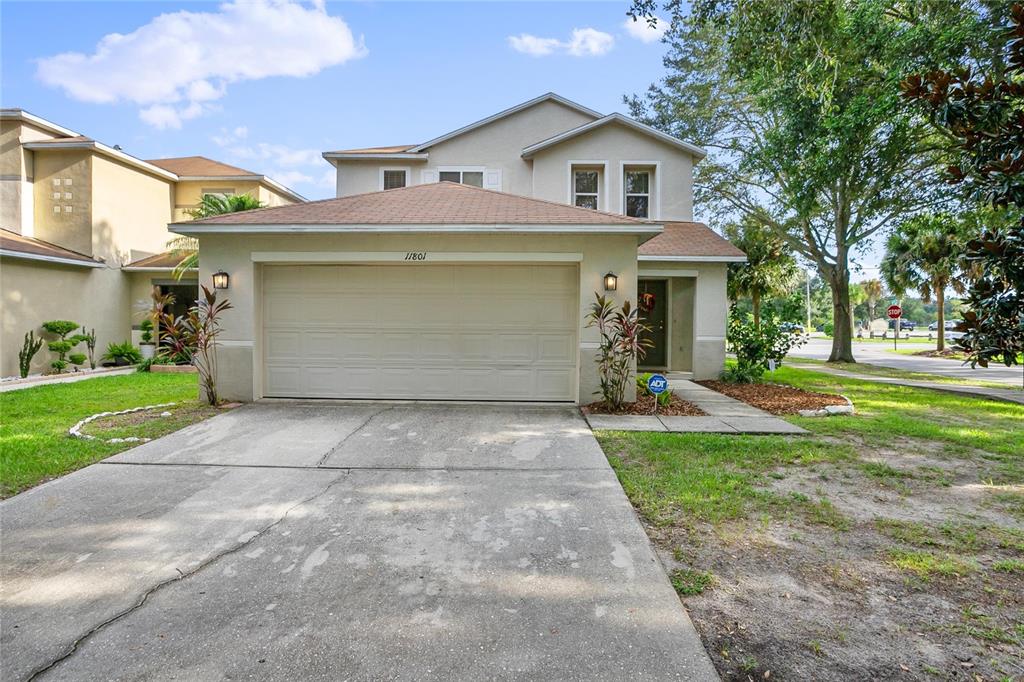 11801 Mango Cross Court Seffner, FL 33584 - Photo 1 of 1 a front view of a house with a yard and garage
