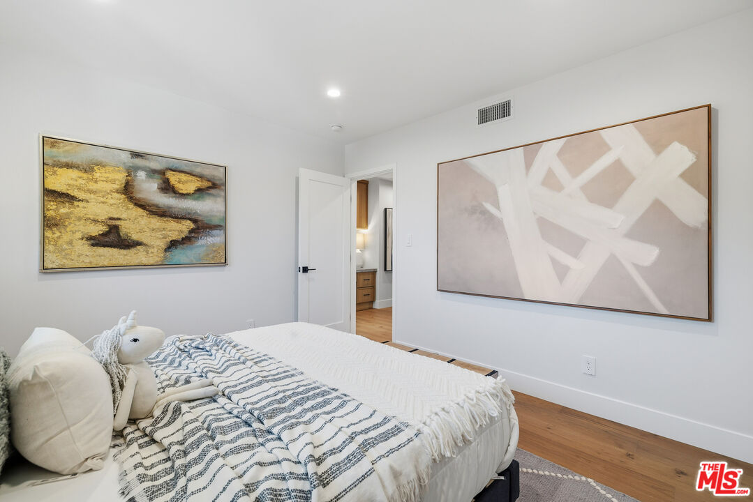 5032 Bluebell Avenue Valley Village, CA 91607 - Photo 11 of 75 a bedroom with a bed and painting on the wall