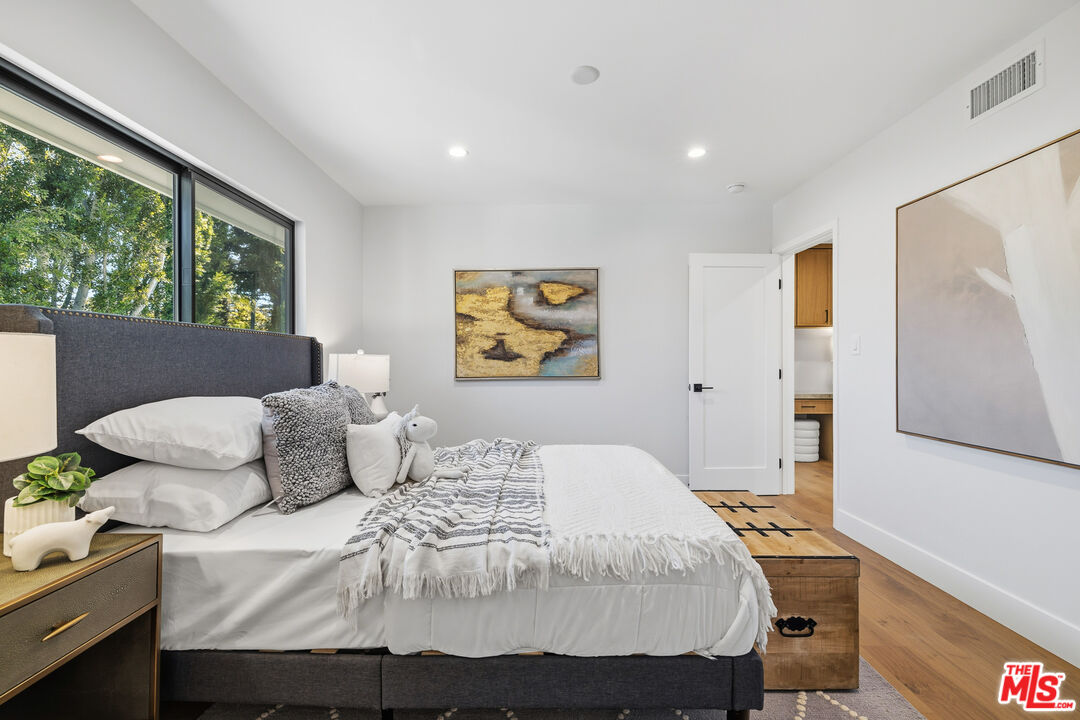5032 Bluebell Avenue Valley Village, CA 91607 - Photo 13 of 75 a bedroom with a bed and wooden floor
