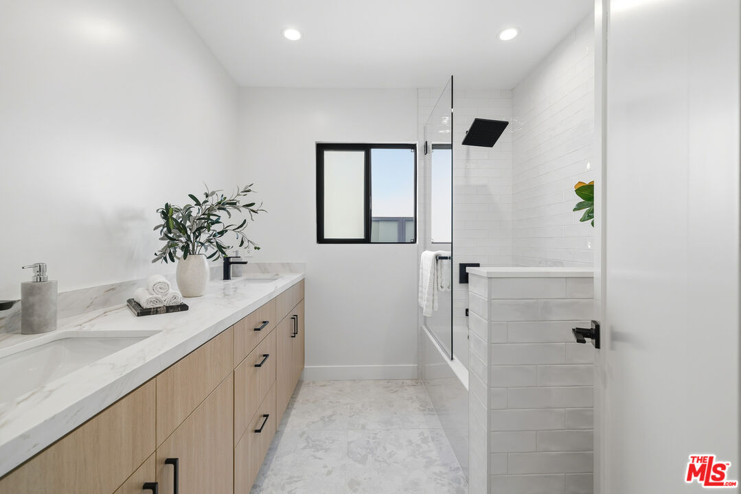 5032 Bluebell Avenue Valley Village, CA 91607 - Photo 15 of 75 a bathroom with a double vanity sink mirror and shower