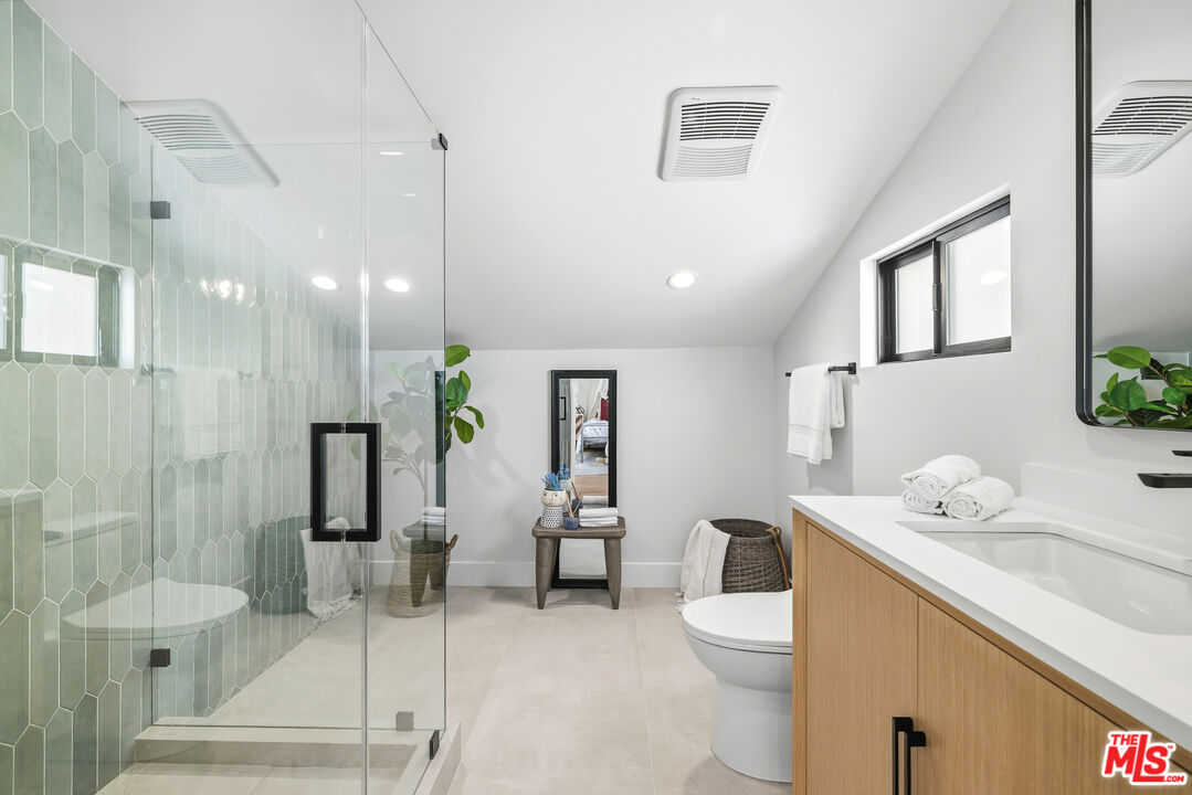 5032 Bluebell Avenue Valley Village, CA 91607 - Photo 20 of 75 a spacious bathroom with a granite countertop sink a toilet and shower