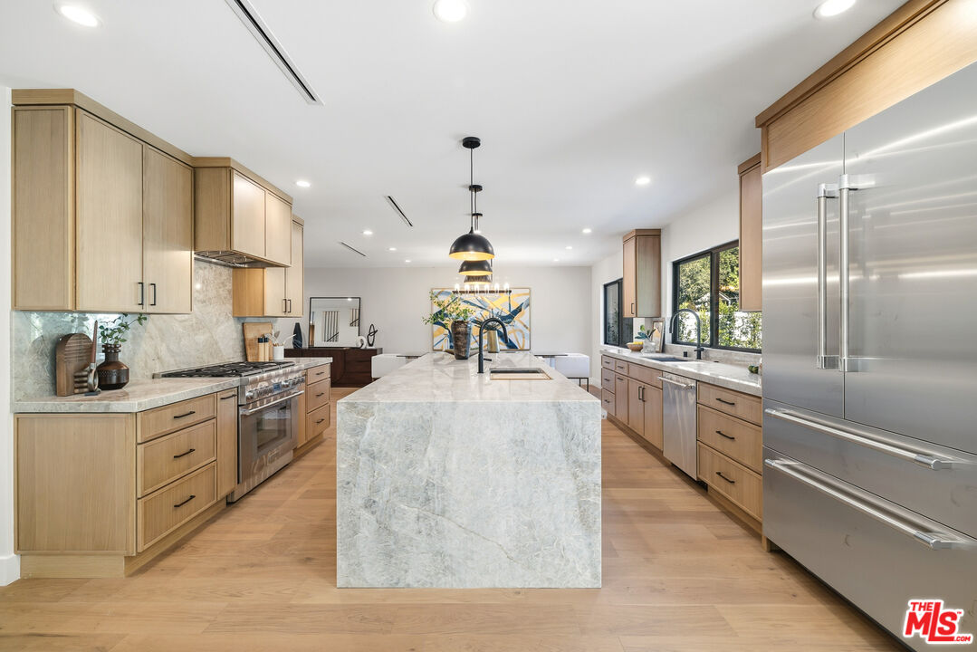 5032 Bluebell Avenue Valley Village, CA 91607 - Photo 22 of 75 a kitchen with sink cabinets and stainless steel appliances