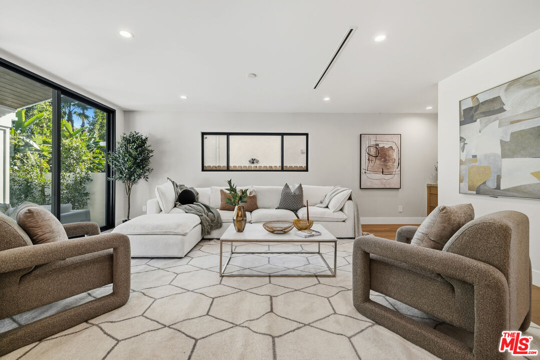 5032 Bluebell Avenue Valley Village, CA 91607 - Photo 9 of 75 a living room with furniture and a large window